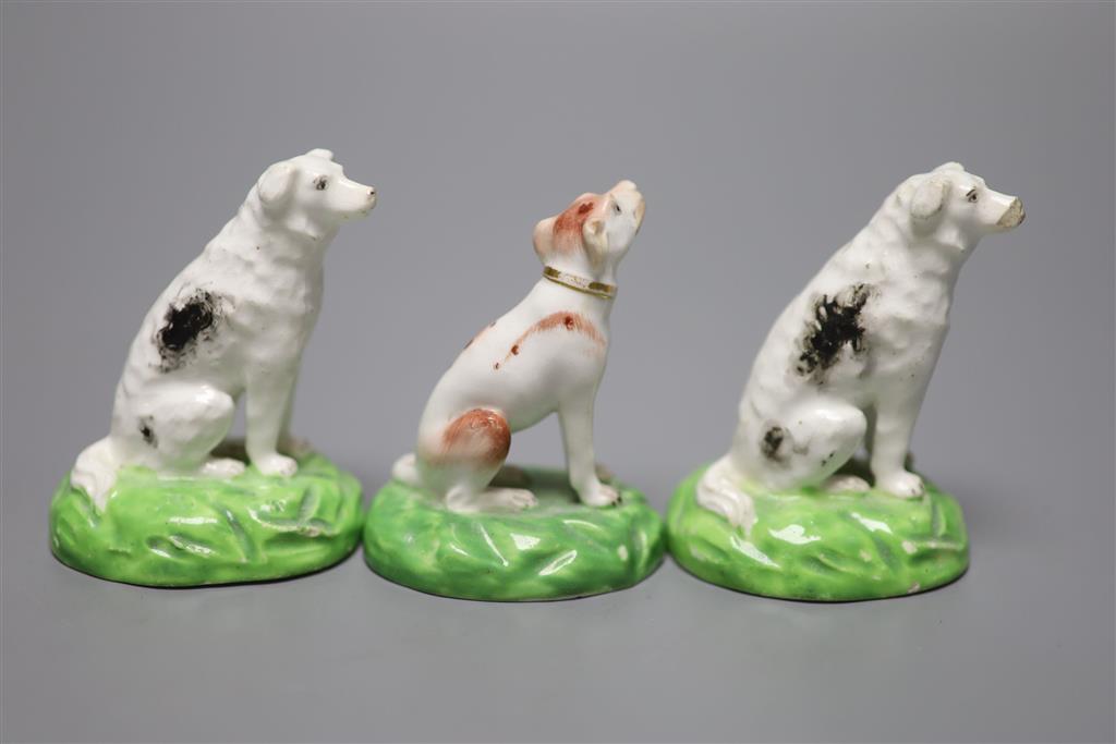 A pair of Staffordshire porcelain figures of seated dogs, height 6.5cm, and another, c.1830-50